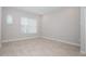Spacious bedroom with wood-look tile flooring and ample natural light from the large window at 922 Wild Date Ln, Lake Mary, FL 32746
