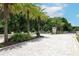 Gated community entrance with brick-paved road, mature landscaping, and a guard house at 922 Wild Date Ln, Lake Mary, FL 32746