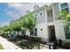 Charming townhouse with a welcoming entrance, a black fence and beautiful trees at 922 Wild Date Ln, Lake Mary, FL 32746