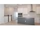 A modern kitchen features white cabinets, stainless steel appliances, and a gray island at 922 Wild Date Ln, Lake Mary, FL 32746