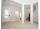 Bright and airy living room with wood-look tile flooring and staircase at 922 Wild Date Ln, Lake Mary, FL 32746