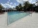 Large community pool with lounge chairs, umbrellas, and a covered pavilion at 922 Wild Date Ln, Lake Mary, FL 32746