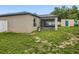 Backyard view featuring a screened lanai and bright yellow shed at 112 Lake Butler Ave, Haines City, FL 33844