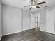 Bedroom with hardwood floors, ceiling fan, neutral walls, and a large closet at 112 Lake Butler Ave, Haines City, FL 33844