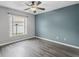 Bright bedroom with a ceiling fan and stylish wood-look flooring at 112 Lake Butler Ave, Haines City, FL 33844