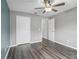Neutral bedroom featuring a ceiling fan, and wood-look flooring at 112 Lake Butler Ave, Haines City, FL 33844