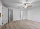 Bright bedroom featuring hard surface floors, a ceiling fan, a closet, and white trim at 112 Lake Butler Ave, Haines City, FL 33844