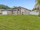 Inviting single-story home with a manicured lawn, white rock landscaping, and a spacious two-car garage at 112 Lake Butler Ave, Haines City, FL 33844