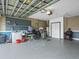 The spacious garage with room for parking and projects features neutral paint and storage solutions at 112 Lake Butler Ave, Haines City, FL 33844