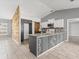 Modern kitchen featuring stylish countertops, white cabinets, and a unique accent wall at 112 Lake Butler Ave, Haines City, FL 33844