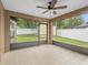 Relaxing screened lanai offering views of the backyard and shed at 112 Lake Butler Ave, Haines City, FL 33844