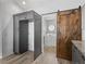 Convenient laundry room with a sliding barn door and modern appliances at 112 Lake Butler Ave, Haines City, FL 33844