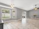 Open-concept living room with tiled floors, neutral walls, and sliding glass doors to the outdoor area at 112 Lake Butler Ave, Haines City, FL 33844