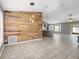 Bright living room featuring tiled floors and a decorative wood wall at 112 Lake Butler Ave, Haines City, FL 33844