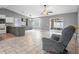 Open-concept living room and kitchen with tiled floors and modern finishes at 112 Lake Butler Ave, Haines City, FL 33844