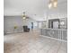 Open-concept living space featuring a kitchen island, modern lighting, and gray walls at 112 Lake Butler Ave, Haines City, FL 33844