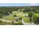 Overhead view captures the property's horse infrastructure, including lush pastures and fenced paddocks at 12434 Sullivan Rd, Clermont, FL 34715