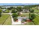 Gorgeous aerial view of the property, showing landscaping, long driveway, and outdoor entertaining space at 12434 Sullivan Rd, Clermont, FL 34715