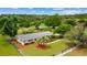 Aerial view of a well-maintained home with sprawling green property and barn at 12434 Sullivan Rd, Clermont, FL 34715