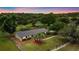 Stunning aerial view of the property with mature trees, a fenced yard, and a long driveway at 12434 Sullivan Rd, Clermont, FL 34715