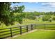 Expansive property with horses grazing in a fenced pasture, showcasing serene countryside living at 12434 Sullivan Rd, Clermont, FL 34715