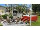 This backyard features a fire pit, outdoor seating, a hot tub, and a charming yellow house at 12434 Sullivan Rd, Clermont, FL 34715