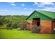 Exterior view of the barn with a metal roof, grassy area, picnic table, and scenic view at 12434 Sullivan Rd, Clermont, FL 34715