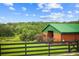 Exterior view of the barn with a metal roof and green grassy area with a picnic table at 12434 Sullivan Rd, Clermont, FL 34715