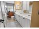 Modern bathroom featuring double sinks, white cabinets, and a shower at 12434 Sullivan Rd, Clermont, FL 34715