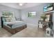 Relaxing bedroom featuring tile flooring and a comfortable bed at 12434 Sullivan Rd, Clermont, FL 34715