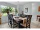 Bright dining room with elegant dark wood table, chairs, and view to the exterior at 12434 Sullivan Rd, Clermont, FL 34715