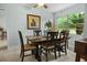 Dining room featuring tile floor, dark wood table, six chairs, and outdoor view at 12434 Sullivan Rd, Clermont, FL 34715