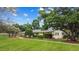 Well-maintained home with manicured lawn and mature trees at 12434 Sullivan Rd, Clermont, FL 34715
