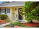 Charming home with inviting front door, decorative accents and lush landscaping at 12434 Sullivan Rd, Clermont, FL 34715