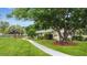 Inviting front yard with a walkway leading to the charming home at 12434 Sullivan Rd, Clermont, FL 34715