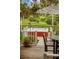 Beautiful deck area featuring a hot tub and seating, with tranquil views of the property at 12434 Sullivan Rd, Clermont, FL 34715