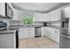 Bright kitchen features stainless steel appliances, white cabinetry, and ample counter space at 12434 Sullivan Rd, Clermont, FL 34715