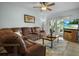 Cozy living room featuring a sectional sofa, sliding glass doors to deck, and flat screen tv at 12434 Sullivan Rd, Clermont, FL 34715