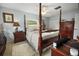 Elegant main bedroom featuring a four-poster bed and tile flooring at 12434 Sullivan Rd, Clermont, FL 34715