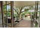 Serene outdoor deck with covered sitting area and views of the surrounding landscape at 12434 Sullivan Rd, Clermont, FL 34715