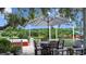 Relaxing outdoor deck featuring seating, dining, lush greenery, and scenic views at 12434 Sullivan Rd, Clermont, FL 34715