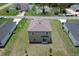 Aerial view of a two-story home with a backyard and adjacent properties at 1303 Congo Ct, Kissimmee, FL 34759
