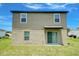 Two-story home with sliding glass doors to the backyard at 1303 Congo Ct, Kissimmee, FL 34759