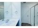 Well-lit bathroom with a single vanity and a glass-enclosed shower at 1303 Congo Ct, Kissimmee, FL 34759
