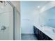 Modern bathroom featuring a double vanity with two sinks and a glass-enclosed shower at 1303 Congo Ct, Kissimmee, FL 34759