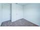 A simply designed bedroom with two doors and neutral carpeting, enhancing functionality and ease of access at 1303 Congo Ct, Kissimmee, FL 34759