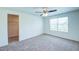 Comfortable bedroom features a ceiling fan, large window, and walk-in closet at 1303 Congo Ct, Kissimmee, FL 34759