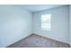 Bright bedroom features a window with blinds and neutral carpet at 1303 Congo Ct, Kissimmee, FL 34759