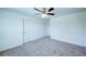 Clean bedroom showcasing neutral carpet, a ceiling fan, and white walls for a minimalist design at 1303 Congo Ct, Kissimmee, FL 34759