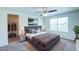Spacious bedroom with a ceiling fan, a large window, and a walk-in closet at 1303 Congo Ct, Kissimmee, FL 34759